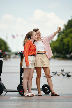 Taking Selfie with Friend on Sunny Day Outdoorsの写真素材