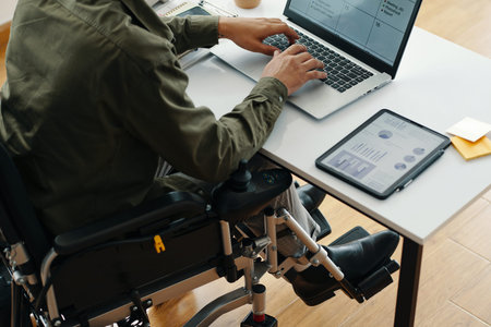 Man With Disability Typing Graphics On Laptop