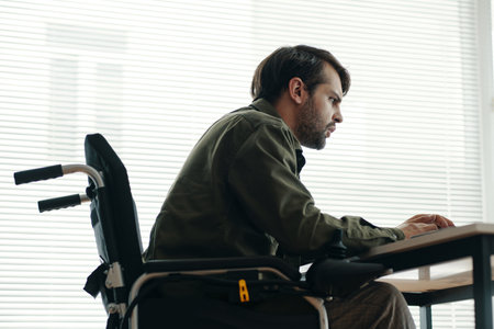 Man With Disability Concentrating On His Workの写真素材
