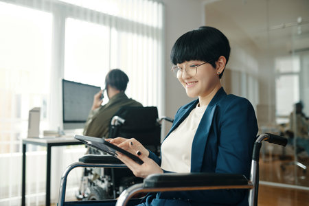 Woman With Disability Working On Tablet PCの写真素材