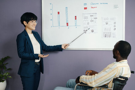 Businesswoman Presenting Graphics To Her Colleague