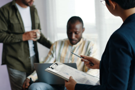 Businesswoman With Report Working With Colleaguesの写真素材