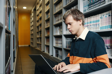 Student Working On Laptop In The Library