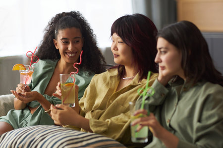 Gen Z Girls Relaxing In Living Room During Party