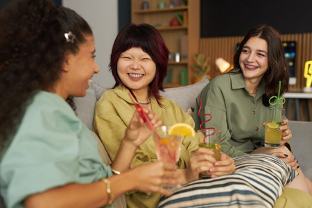 Girls Chatting During Party In Living Roomの写真素材