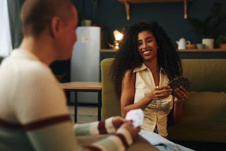 Sharing Laughter With Friends While Playing Cards