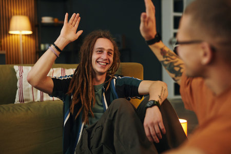 Greeting and Smiling Friends Giving High Five Indoors
