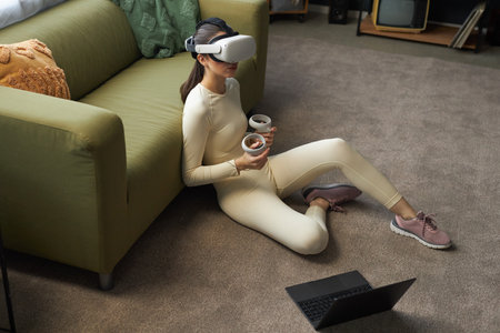 Experiencing Virtual Reality While Sitting on Modern Sofaの写真素材