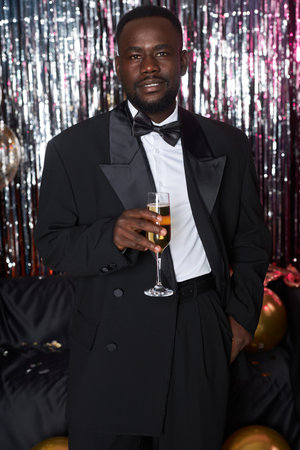 Portrait of Smiling Man Holding Champagne at Party Celebrationの写真素材