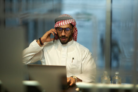 Middle Eastern Man In Traditional Clothes Talking on Phone