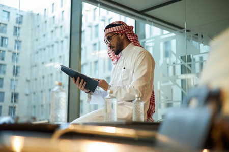 Young Middle Eastern Man Working with Documents
