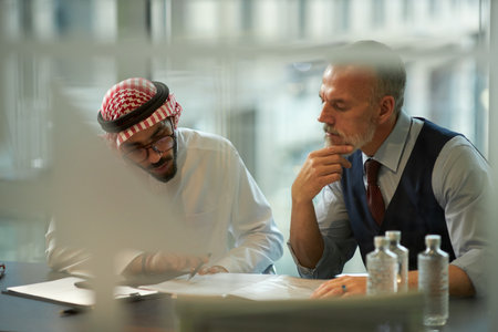 Two Diverse Men Doing Paperwork in Officeの写真素材