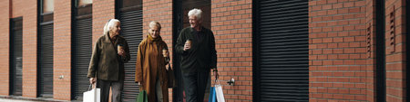 Header of three senior Caucasian women walking outdoors carrying shopping bags and holding takeaway...