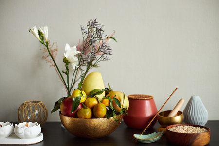 Still life arrangement featuring bowl of fresh fruit including pears, apples, and citrus alongside...