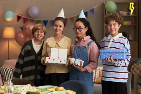 Group of four teenagers, including Caucasian boy, Caucasian girl, Asian girl, and boy of possible...