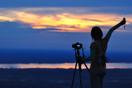 Women Nature photographer with digital camera on the mountainの写真素材