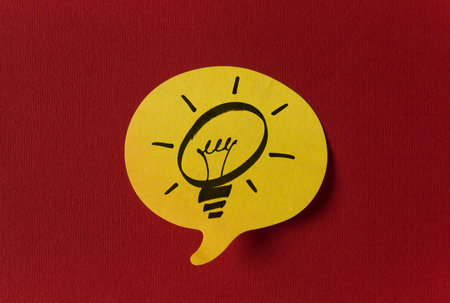 Yellow sticker with shape of speech bubble on red backgroundの写真素材