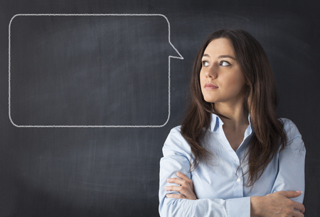 Woman with talking bubble on blackboard.の写真素材