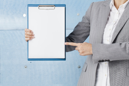 Businesswoman holding blank clipboardの写真素材