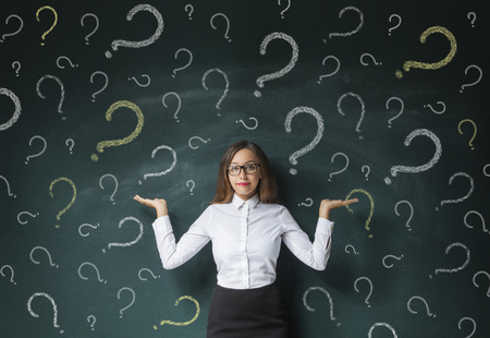 Business woman with question mark on a blackboardの写真素材
