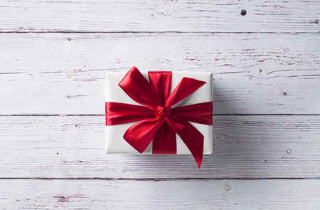 Christmas present on white wooden table. Flat lay with copy space.の写真素材