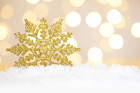 Gold Christmas snowflake ornament with tree lightsの写真素材