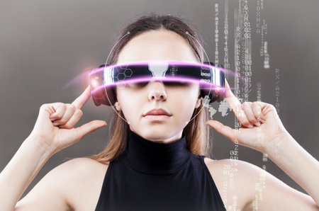 Woman with futuristic smart glasses on grey background