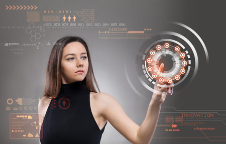 Young woman touching the virtual future interface