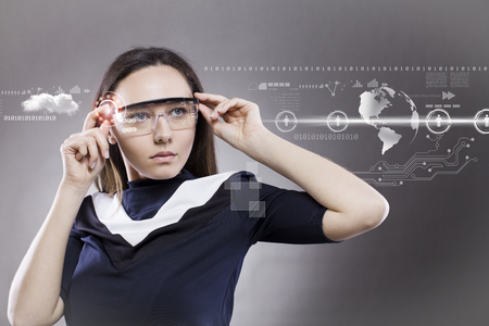 Woman with futuristic smart glasses on grey backgroundの写真素材