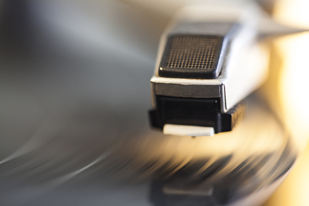Spinning vinyl record. Motion blur image. Bright view. Shallow depth of field.の写真素材