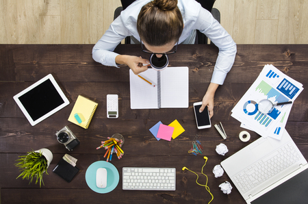 Woman Working And Drinking Coffee In Officeの写真素材