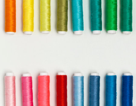 Multicolor sewing threads on white background