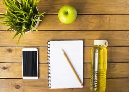 Pencil, Notebook and Apple on a Wood Backgroundの写真素材