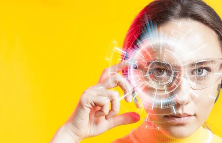 Young woman looking at virtual graphics in futuristic backgroundの写真素材