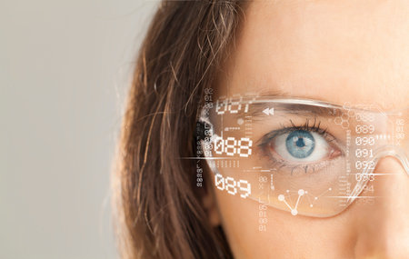 Young woman looking at virtual graphics on grey background