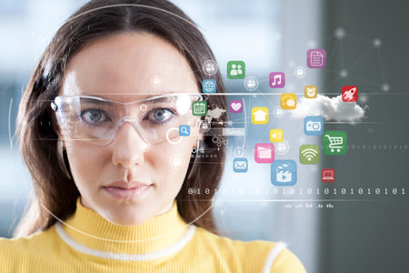 Young woman looking at virtual graphics in blurry background