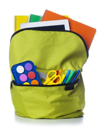 Green school backpack with school supplies isolated on white backgroundの写真素材