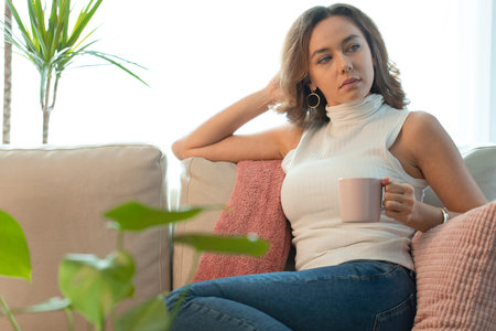 Frustrated confused female feels unhappy problem in personal life. Upset woman looking away sitting...
