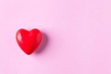 Red Heart on pink background 
