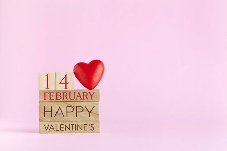 Cube calendar for 14 February on pink background with text Happy Valentine`s Dayの写真素材