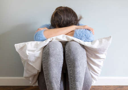 Woman hands with gloves wiping mobile phone while working from home. Protecting herself during    pandemic infectious disease outbreakの写真素材