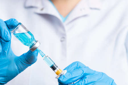 Doctor filling syringe with medication. Vaccination and immunizationの写真素材