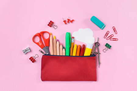 Back to school concept. Pencil case on pink background