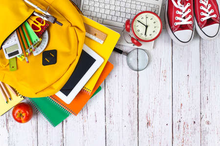 Back to school concept. Backpack with school supplies. Top view. Wooden background. Copy space.の写真素材