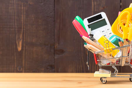 Stationery and office supplies in a miniature shopping cart. Back to schoolの写真素材