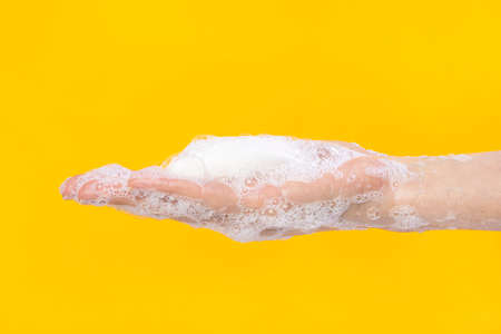 Woman washing hands with soap. Closeup of female washing hands isolatedの写真素材