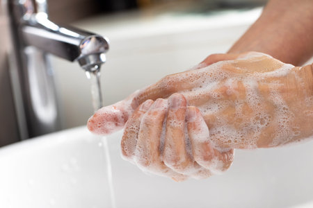 Man washing hands in the bathroom at home