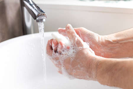 Man washing hands in the bathroom at homeの写真素材
