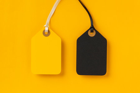 Sale tags on yellow background for Black Friday conceptの写真素材