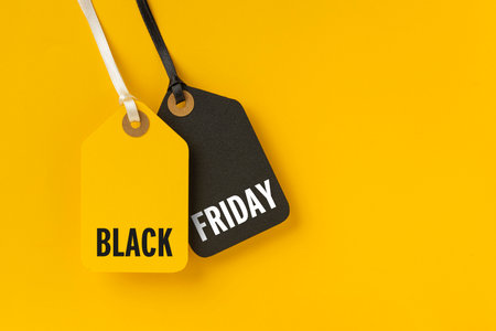 Sale tags with Black Friday written on yellow background for Black Friday conceptの写真素材